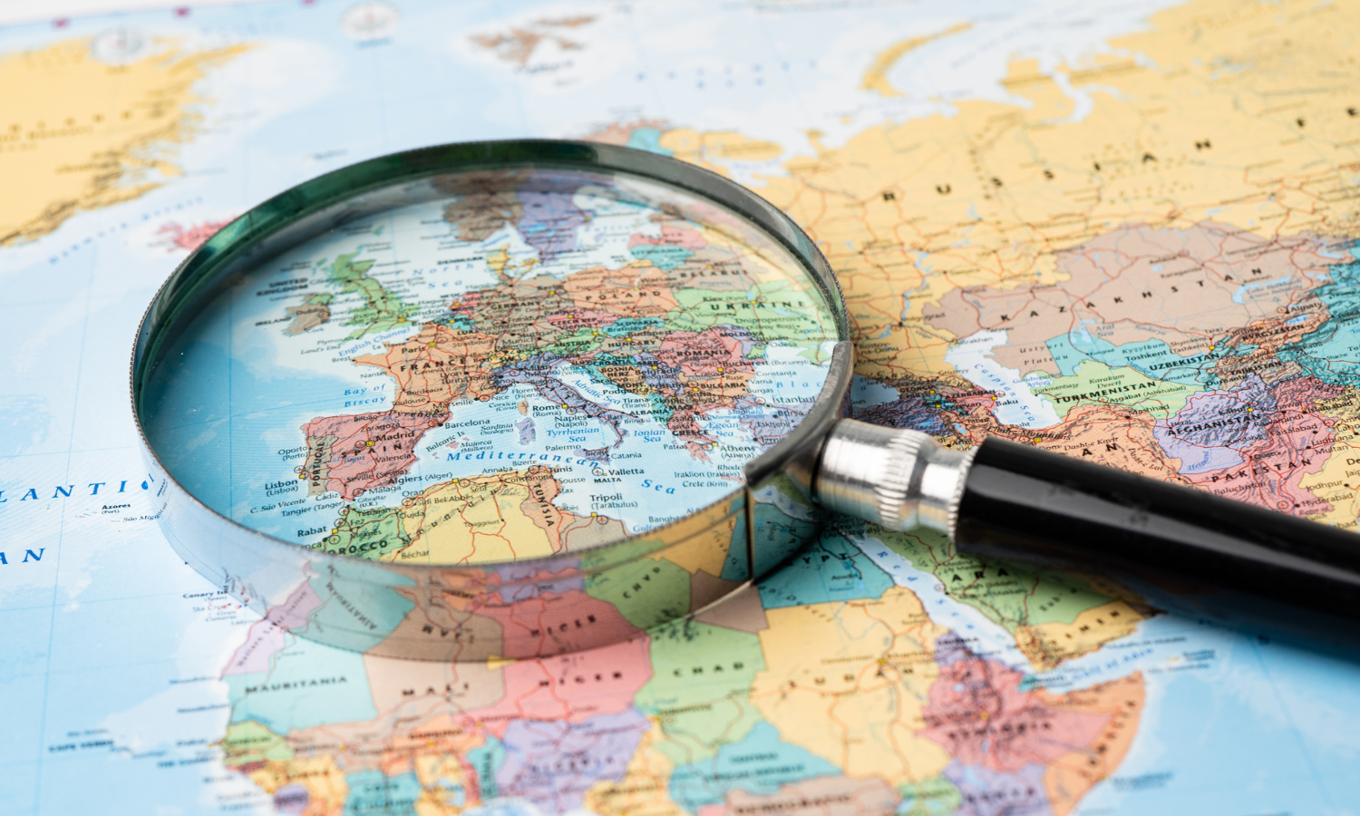 A map of Europe with a magnifying glass laid over the top
