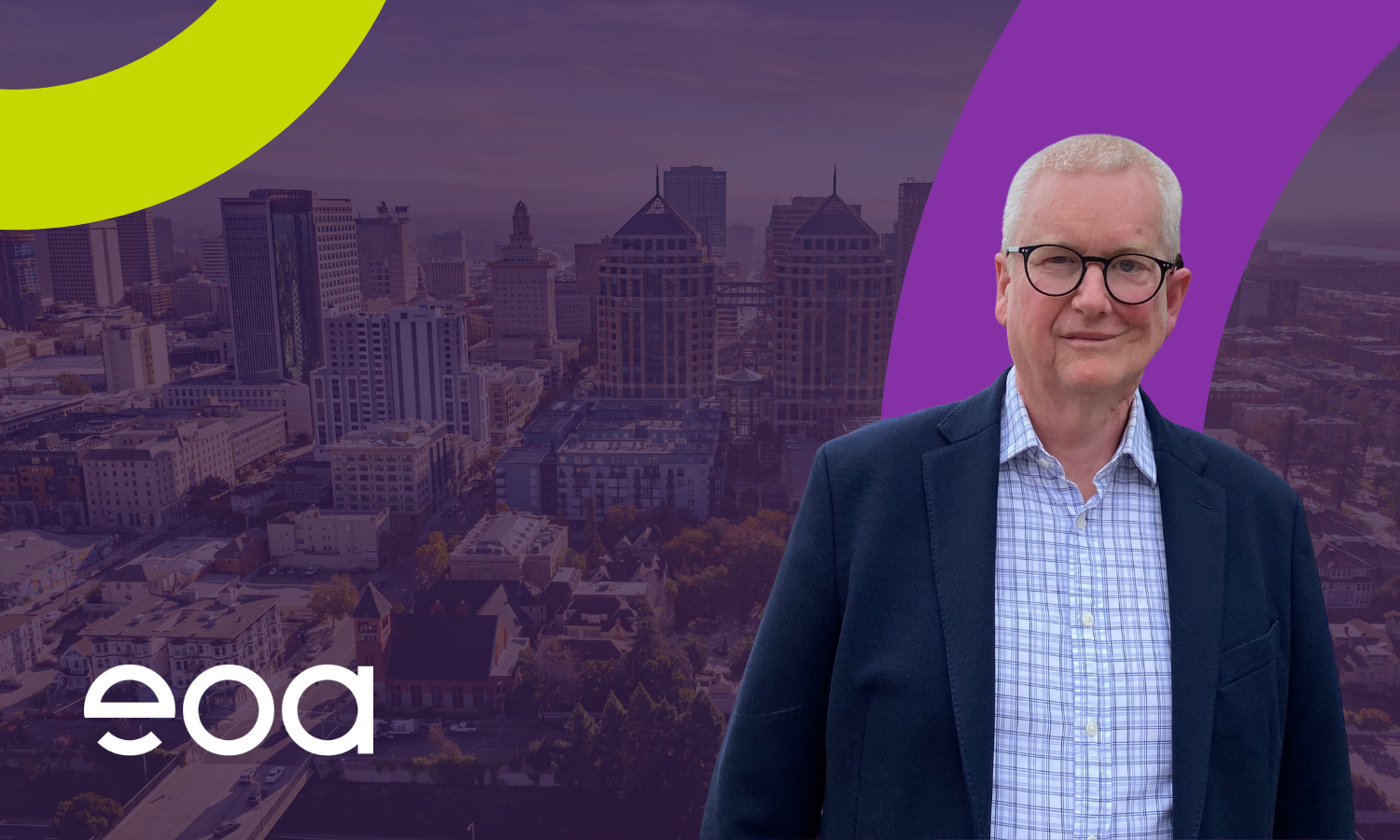 A short haired middle aged man against a cityscape